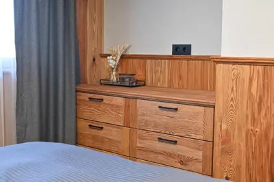 a wooden dresser in a bedroom with a bed at Cozy 1-Bedroom Apartment in St Ivan Ski Resort by Flat Mаnаger in Blagoevgrad