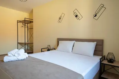 a bedroom with a bed with towels on it at Apartment By The River 5 in Plovdiv