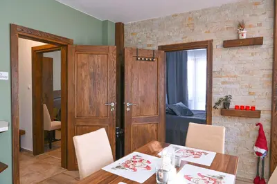 a room with a table and a room with a bedroom at Comfortable 2-Bedroom Apartment Near the Ski Lift by Flat Mаnаger in Bansko