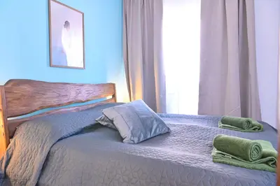 a bedroom with a bed with two towels on it at Comfortable 2-Bedroom Apartment Near the Ski Lift by Flat Mаnаger in Bansko