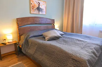 a bedroom with a bed with a pillow on it at Comfortable 2-Bedroom Apartment Near the Ski Lift by Flat Mаnаger in Bansko