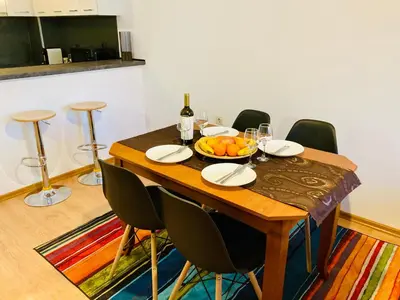 a dining room table with a bowl of fruit on it at Spacious & Classy 2BDR Apartment with 2 Baths in Plovdiv Centre in Plovdiv