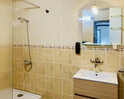 a bathroom with a sink and a shower at Spacious & Classy 2BDR Apartment with 2 Baths in Plovdiv Centre in Plovdiv