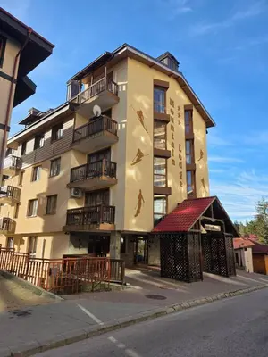 a building with birds painted on the side of it at TMF Mountain Lodge Cozy Studio apartment in Pamporovo