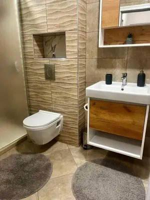a bathroom with a toilet and a sink at Raya - Apartmant in Plovdiv, with private parking in Plovdiv