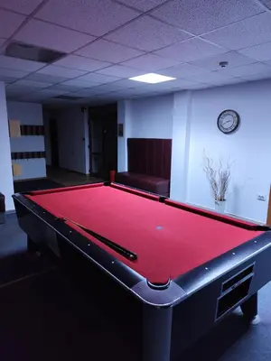 a pool table in an office with a couch at Замъка in Pamporovo