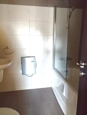a bathroom with a shower and a tub and a sink at Dreaming apartment with tree Mountain view in Borovets