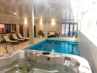 a bath tub sitting next to a swimming pool at Dreaming apartment with tree Mountain view in Borovets