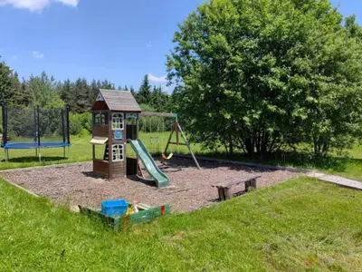 a playground with a slide and a swing at Dreaming apartment with tree Mountain view in Borovets