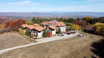 an aerial view of a large house on a hill at Dreaming apartment with tree Mountain view in Borovets