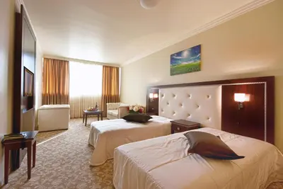 a hotel room with two beds and a couch at Hotel Chiirite in Plovdiv