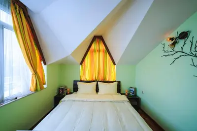 a bed in a room with a large window at Fantasy in Bansko