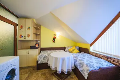 a small bedroom with a bed with a table at Fantasy in Bansko