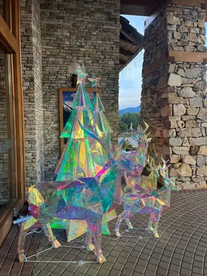 a painting of a christmas tree and two reindeer at PIRIN GOLF DELUXE PRIVATE STUDIO GABBY ground floor in Bansko
