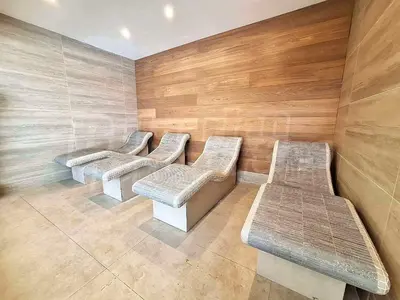 a row of benches in a room with wooden walls at Studio 4, 4min walk to slope at Predela2 Bansko in Bansko