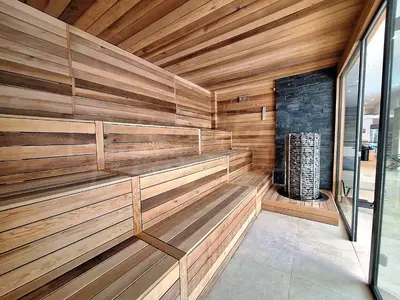 a sauna with wooden walls and a fireplace at Studio 4, 4min walk to slope at Predela2 Bansko in Bansko