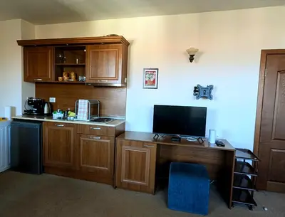 a kitchen with a desk with a tv on it at Mountain view apartment at Emerald Hotel in Bansko