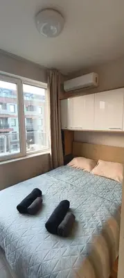 two black pillows on a bed in a bedroom at VB Residence Vitosha View Apartment in Sofia
