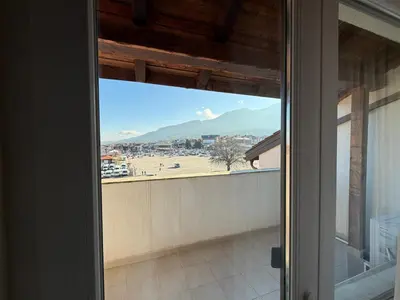 a sliding glass door with a view of a mountain at Bansko Royal Towers Ski Lift View in Bansko