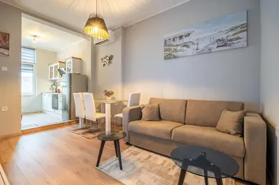 a living room with a couch and a table at The Urban Pulse Stylish Flat in Sofia