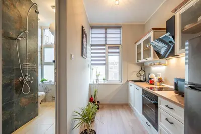 a small kitchen with a sink and a shower at The Urban Pulse Stylish Flat in Sofia