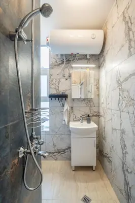 a bathroom with a shower and a sink at The Urban Pulse Stylish Flat in Sofia