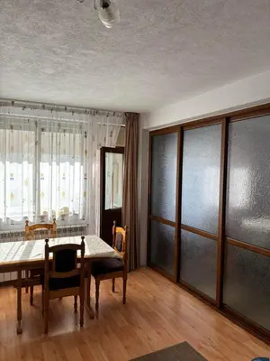 a dining room with a table and chairs at Kiryanov's apartment in Sandanski