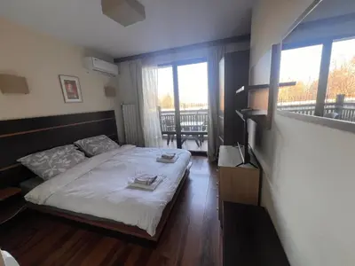 a bedroom with a bed with two towels on it at Princeps De Cura Bansko in Bansko