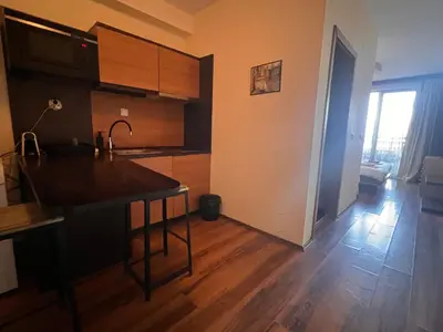 a kitchen with a kitchen island in a room at Princeps De Cura Bansko in Bansko