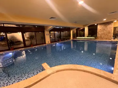a large swimming pool in a hotel at Princeps De Cura Bansko in Bansko
