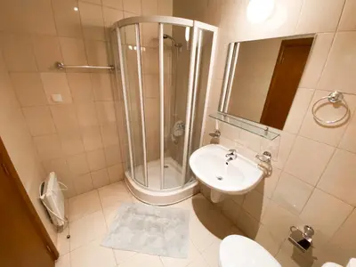a bathroom with a shower and a sink and a toilet at Private Studio 500m from Gondola in Bansko