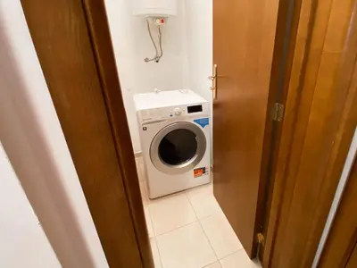 a washer and dryer in a small room at Private Studio 500m from Gondola in Bansko