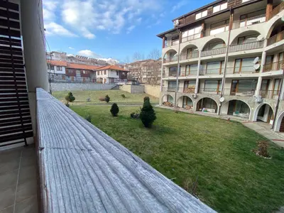 a view from a balcony of a building with a yard at Private Studio 500m from Gondola in Bansko
