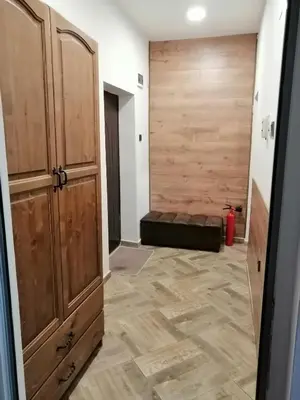 a room with a sliding barn door and a couch at Апартамент Light blue in Troyan