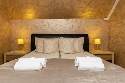 a bedroom with a bed with two towels on it at Square Slivnitsa 2BR apt 5 minutes from top center in Plovdiv
