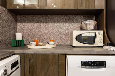 a kitchen with a microwave on a counter at Square Slivnitsa 2BR apt 5 minutes from top center in Plovdiv