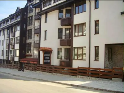 a large white building with balconies on a city street at ElGora Studio в Apart Hotel Comfort in Bansko