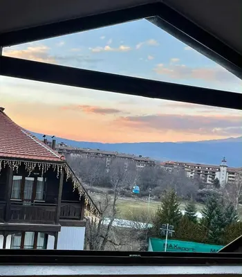 a view of a city from a window at ElGora Studio в Apart Hotel Comfort in Bansko
