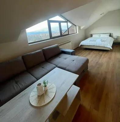 a living room with a couch and a table at ElGora Studio в Apart Hotel Comfort in Bansko