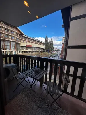 a balcony with a table and chairs on a building at Apartment 35 Mountain Lodge Pamporovo in Pamporovo