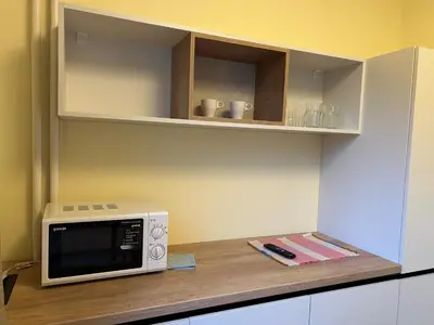 a microwave oven sitting on top of a counter at Flat in Darvenitsa near Church St George the Victorious in Sofia