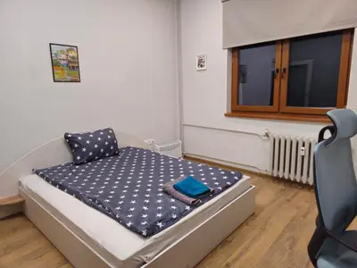 a small bed in a room with a window at 4BR Central Retreat in Sofia