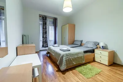 a bedroom with a bed and a dresser and window at Gurko Finest in Sofia