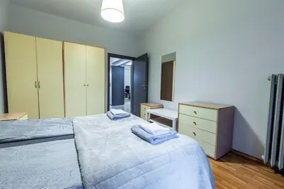 a bedroom with a bed and a dresser with towels on it at Gurko Finest in Sofia