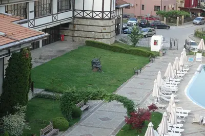 an aerial view of a courtyard with chairs and a pool at Спа Хотел Орфей in Devin