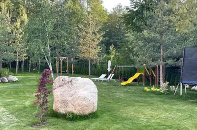 a large rock in a yard with a playground at Predela 2 Aparthotel Ski & Spa 200m from slopes in Bansko