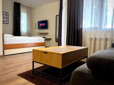 a living room with a bed and a coffee table at Elite Apartments Flora Residence in Borovets