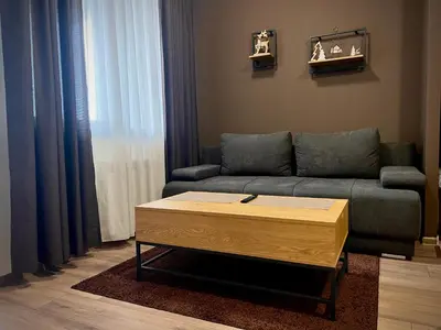 a living room with a couch and a coffee table at Elite Apartments Flora Residence in Borovets