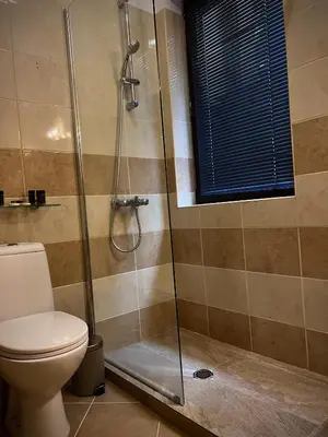 a bathroom with a shower and a toilet at Elite Apartments Flora Residence in Borovets