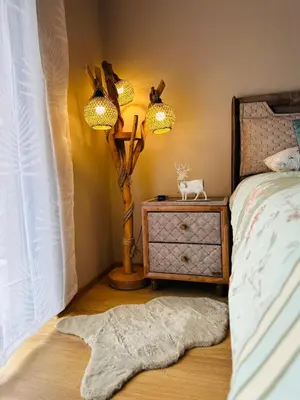 a bedroom with a bed and a nightstand with a tree on it at Борово ухание Говедарци Pine scent Govedartsi in Govedartsi